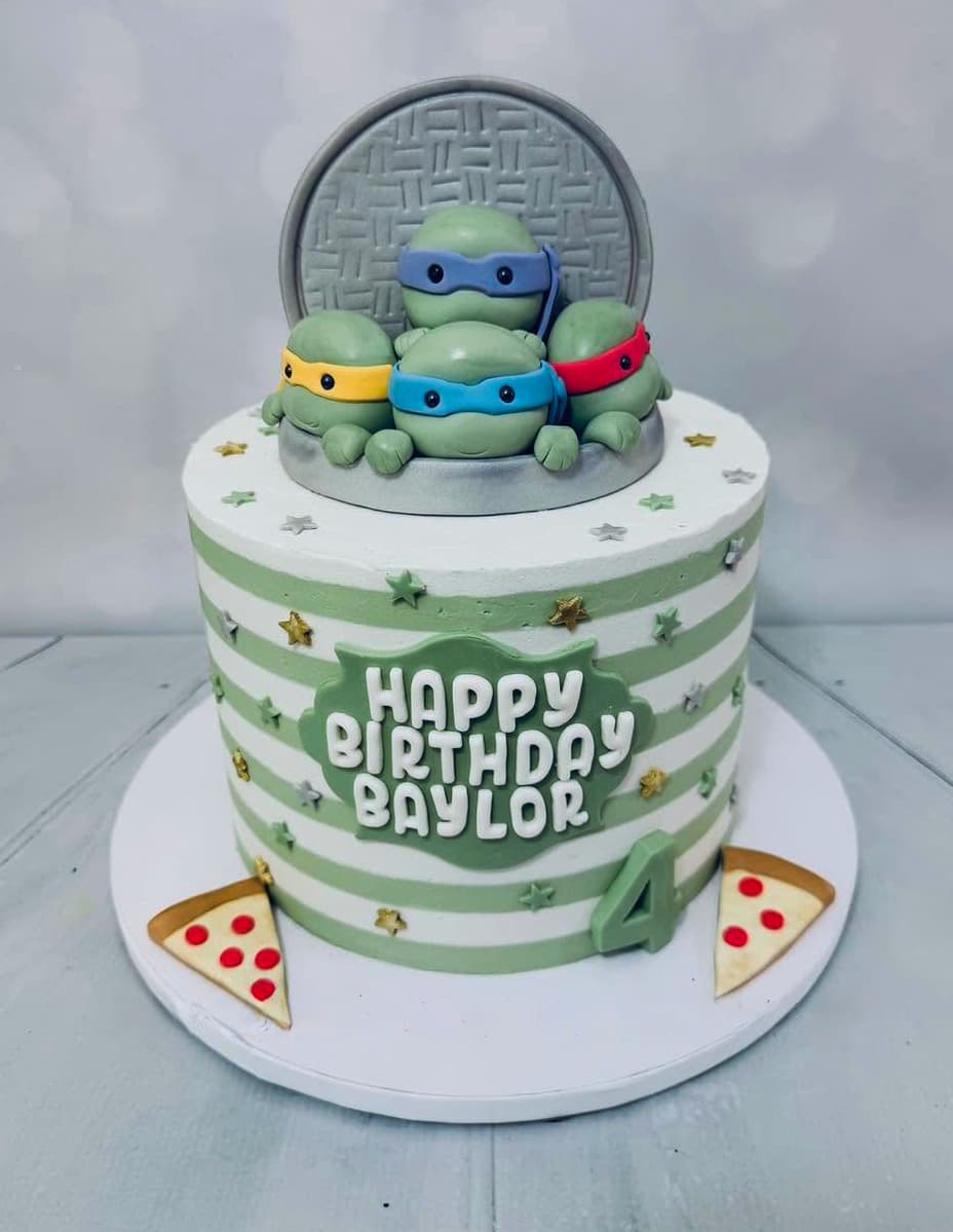 Ninja Turtles inspired birthday cake with four turtle characters and pizza details by Sweet Cakes by Kristen