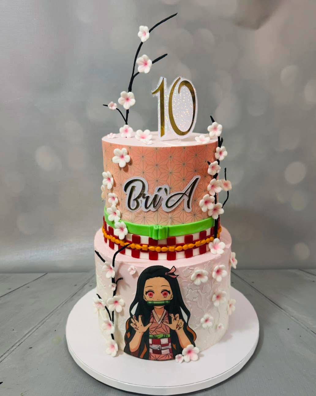 Anime inspired two-tier 10th birthday cake with floral decorations by Sweet Cakes by Kristen