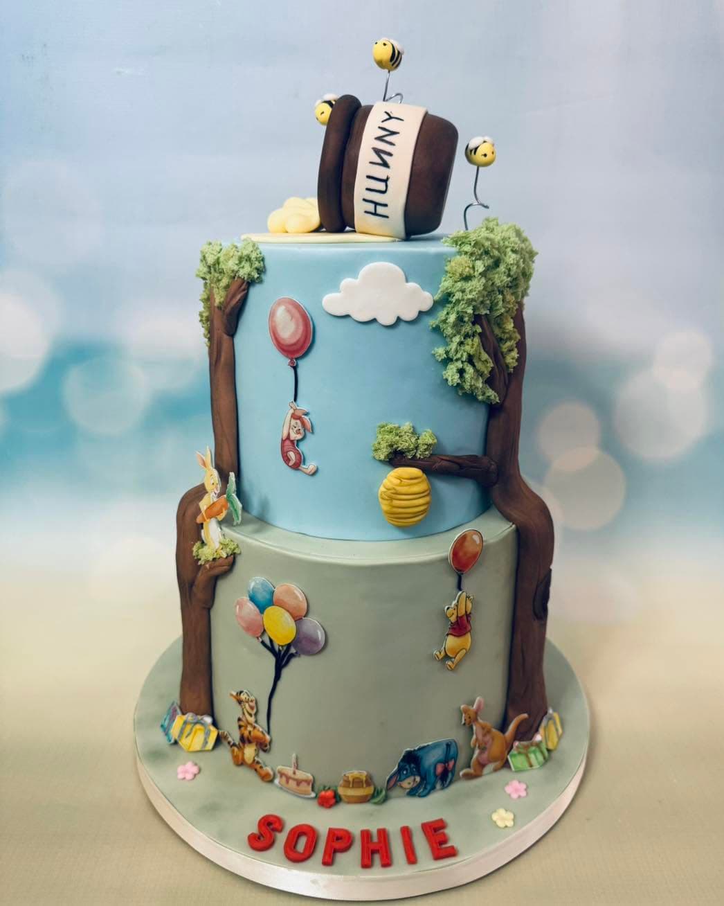 Winnie the Pooh inspired first birthday cake with woodland and honey themed details by Sweet Cakes by Kristen
