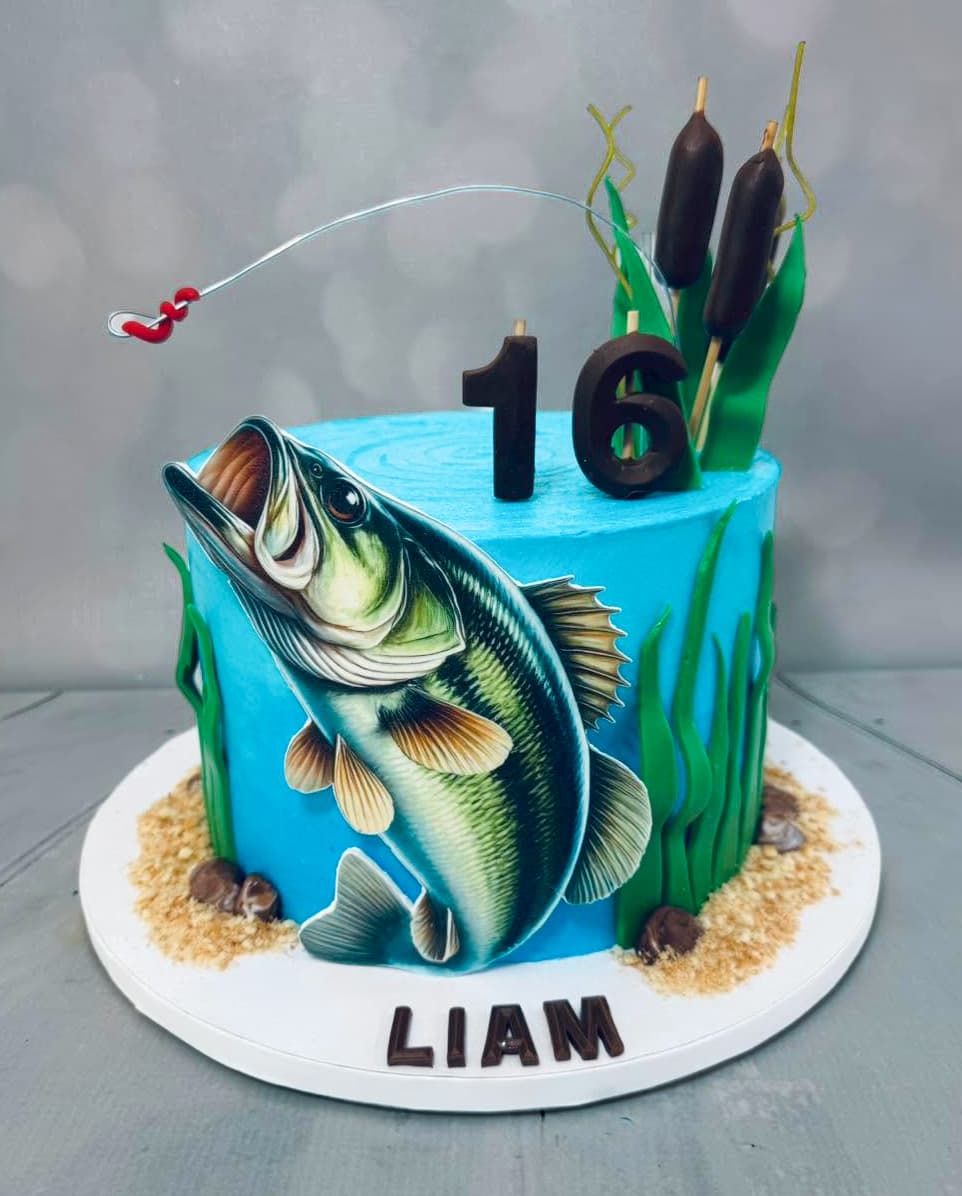 Fishing themed birthday cake with fish cattails and fishing pole details by Sweet Cakes by Kristen