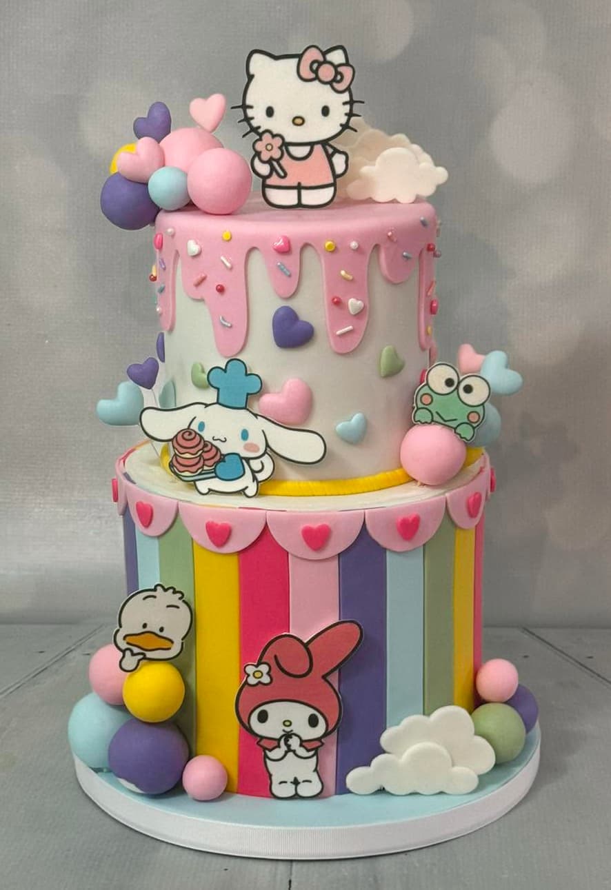 Colorful two-tier Hello Kitty inspired birthday cake with pastel character decorations by Sweet Cakes by Kristen
