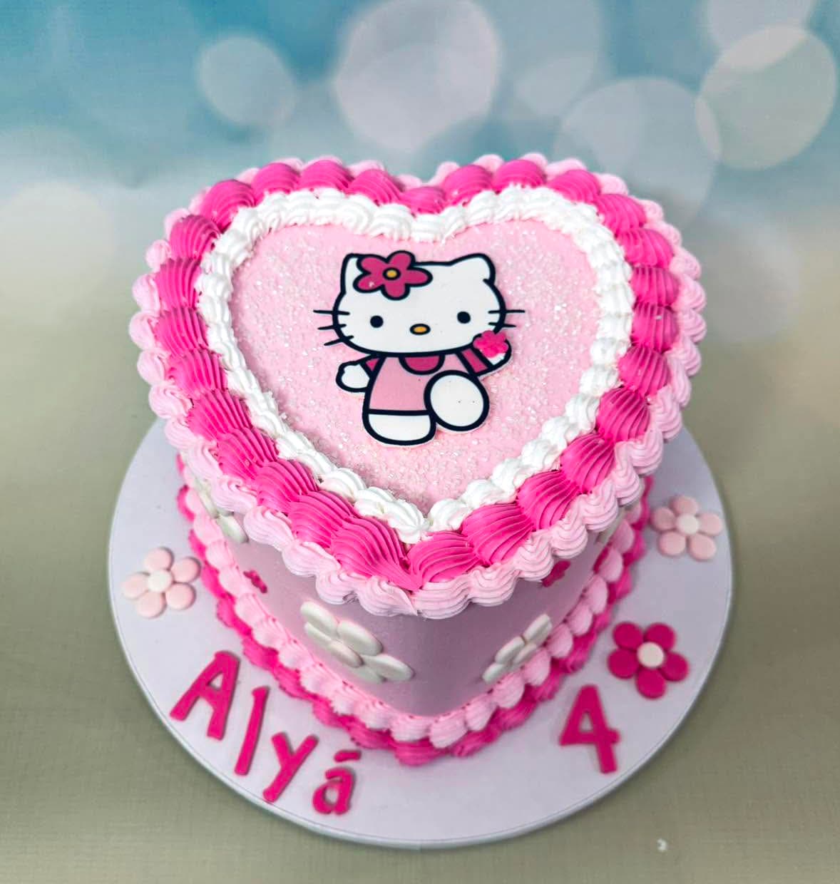Pink heart shaped Hello Kitty inspired birthday cake by Sweet Cakes by Kristen