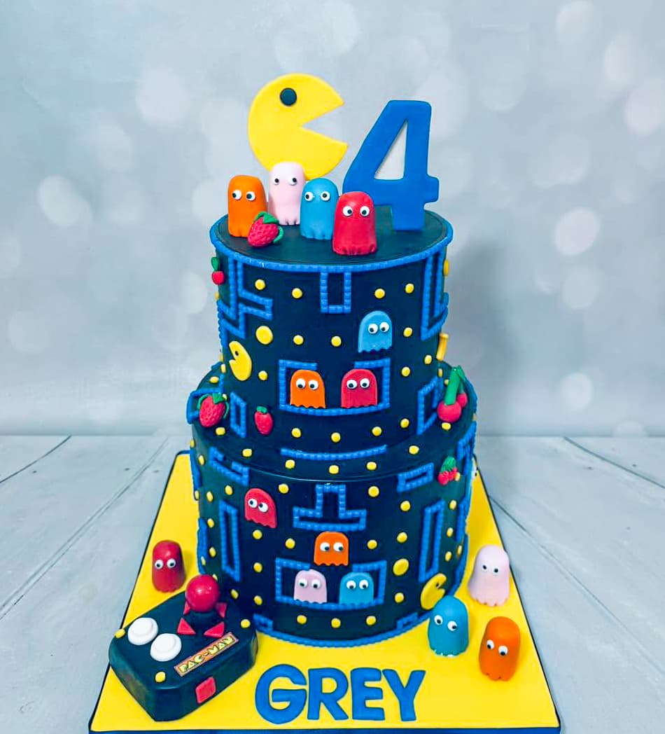 Pac-Man themed two-tier birthday cake with arcade game characters by Sweet Cakes by Kristen