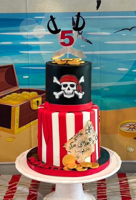 Pirate themed birthday cake with treasure chest skull and pirate decorations by Sweet Cakes by Kristen