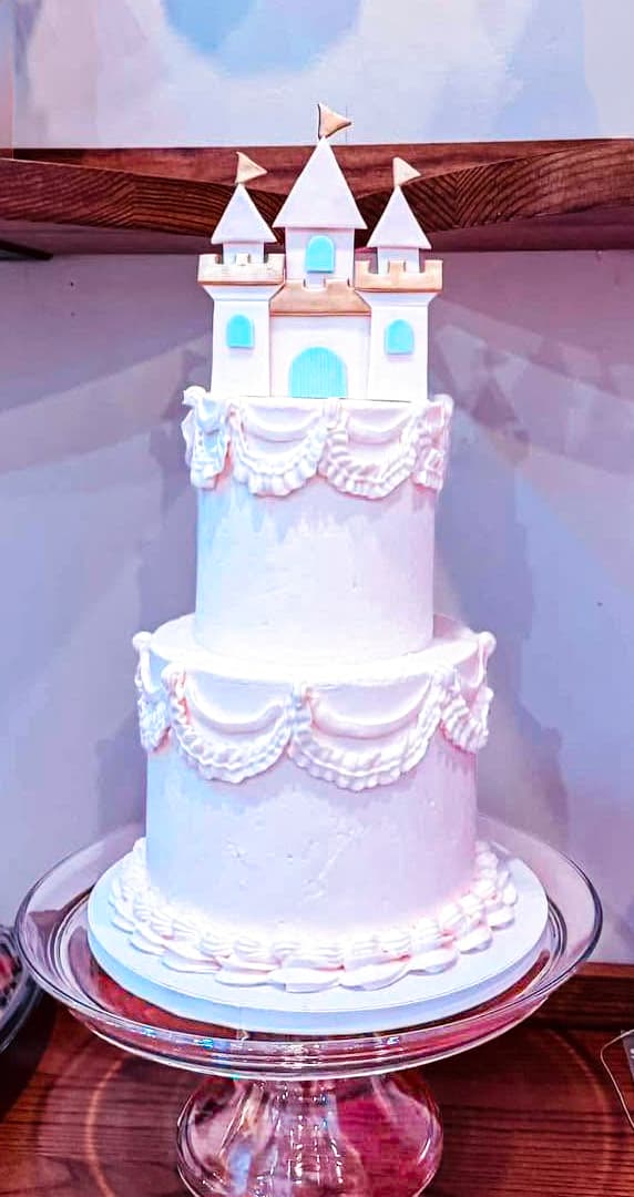 Princess castle birthday cake with pink tiers and castle topper by Sweet Cakes by Kristen