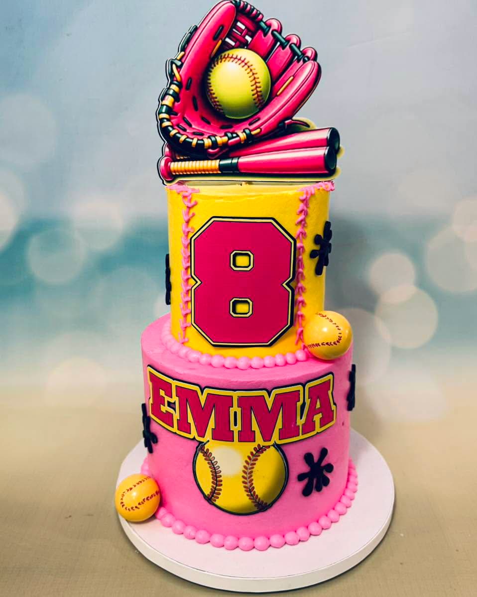 Pink and yellow softball themed two-tier birthday cake by Sweet Cakes by Kristen