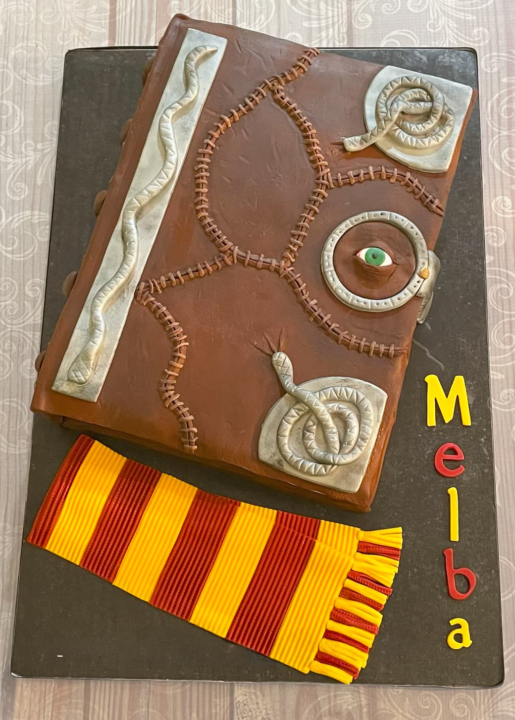 Harry Potter inspired Monster Book of Monsters sculpted cake with scarf by Sweet Cakes by Kristen
