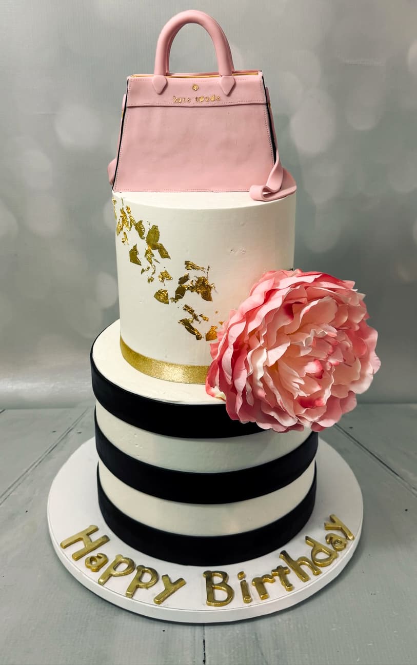 Realistic three-dimensional sculpted purse cake by Sweet Cakes by Kristen