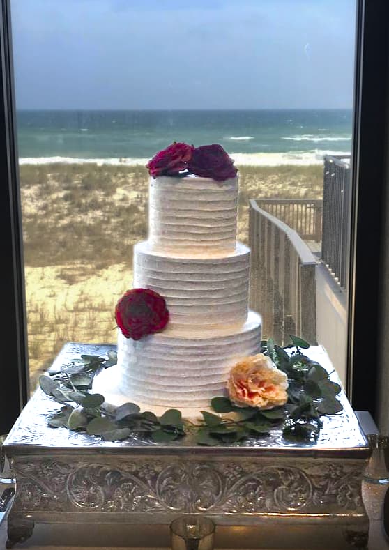 Tiered beach wedding cake with textured buttercream and flowers overlooking the Gulf Coast by Sweet Cakes by Kristen