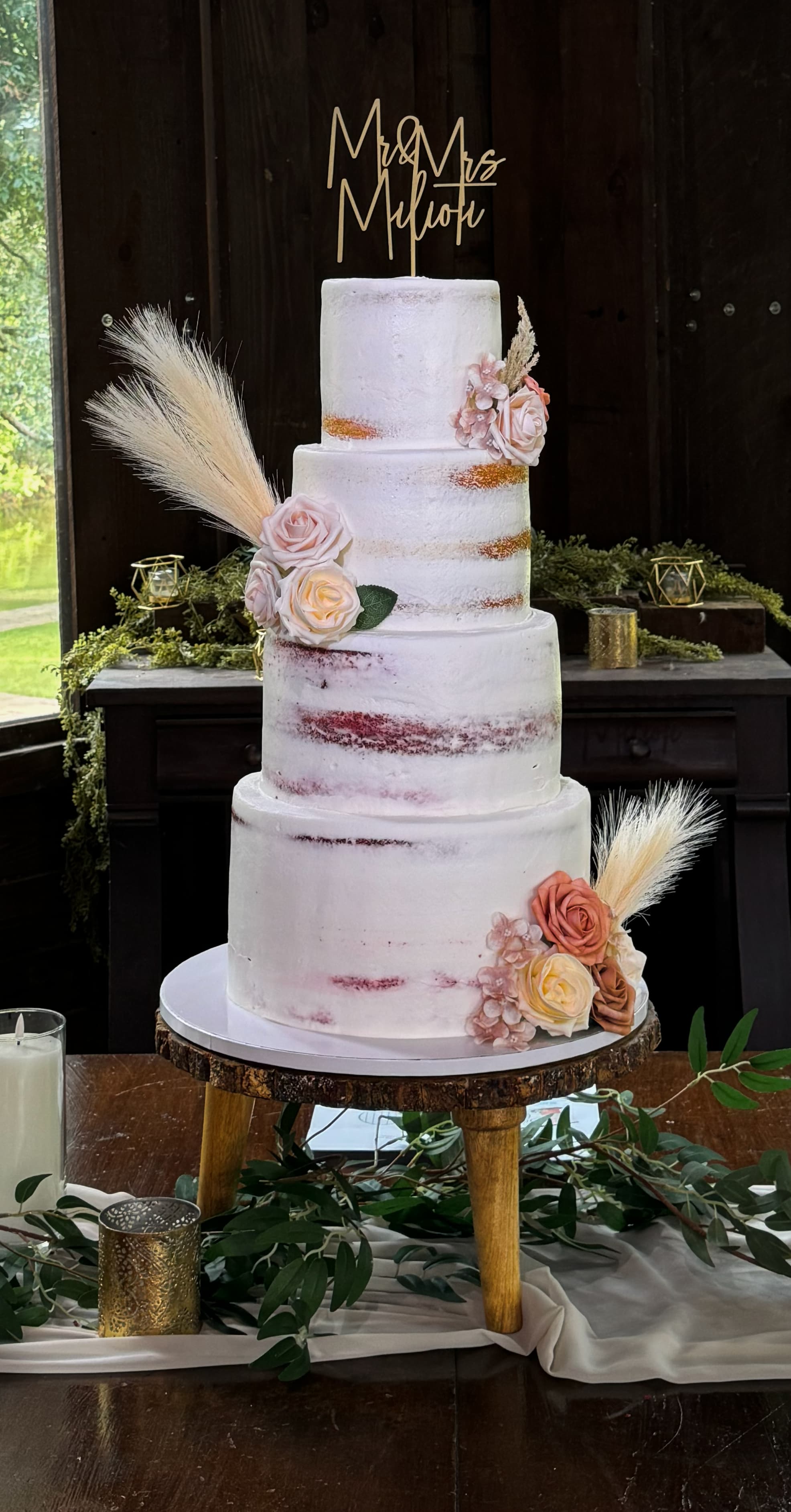 Tall tiered wedding cake with soft pink flowers and elegant rustic details by Sweet Cakes by Kristen